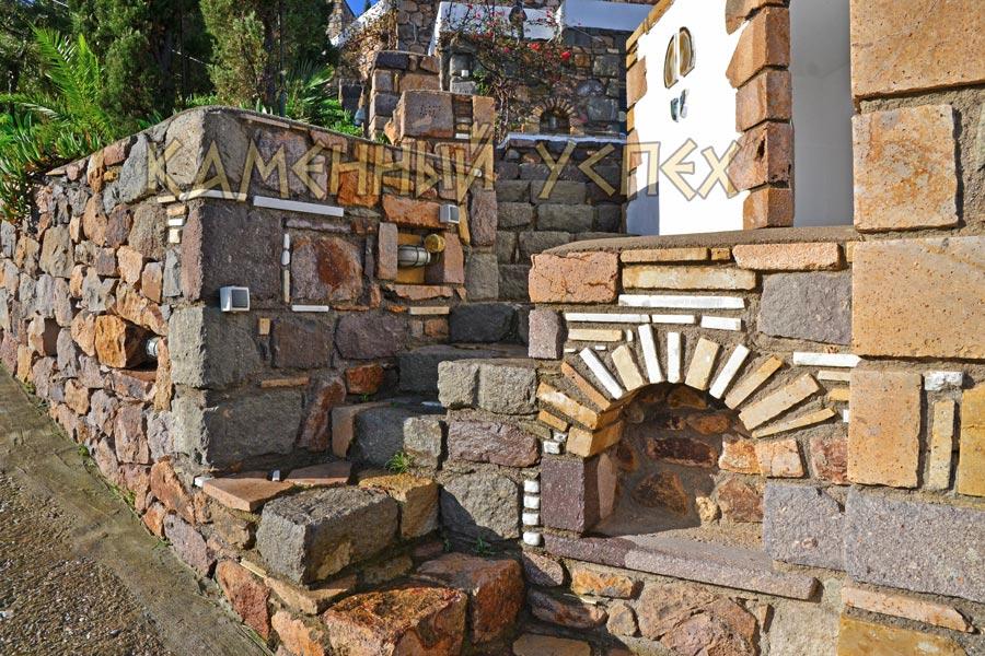 stone retaining wall with niche arch